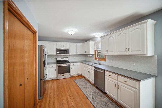 2870 Gannet Ln, New Lenox, IL 60451 - kitchen with stainless steel appliances, tasteful backsplash, light wood-style floors, and white cabinets