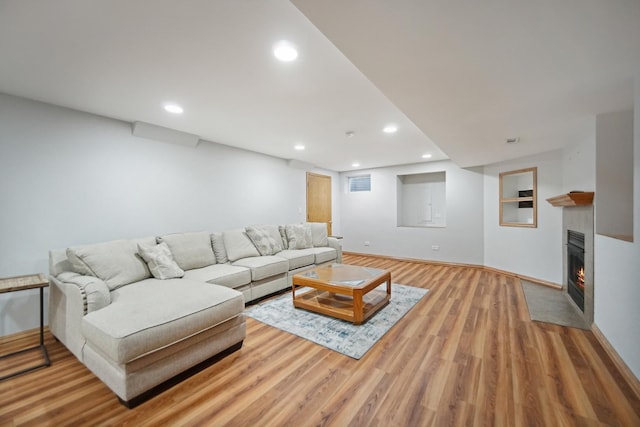 2870 Gannet Ln, New Lenox, IL 60451 - living room featuring recessed lighting, wood finished floors, a fireplace with flush hearth, and built in features