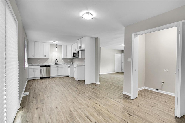 549 Allen Ln, University Park, IL 60484 - kitchen with appliances with stainless steel finishes, white cabinets, light wood-style floors, and light countertops