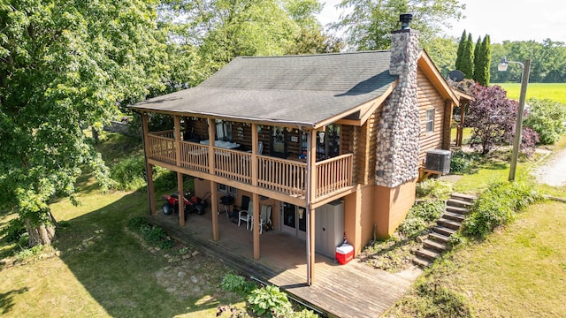 20340 Rt 113th Hwy, Wilmington, IL 60481 - rear view of house with log siding, a deck, a yard, and a chimney