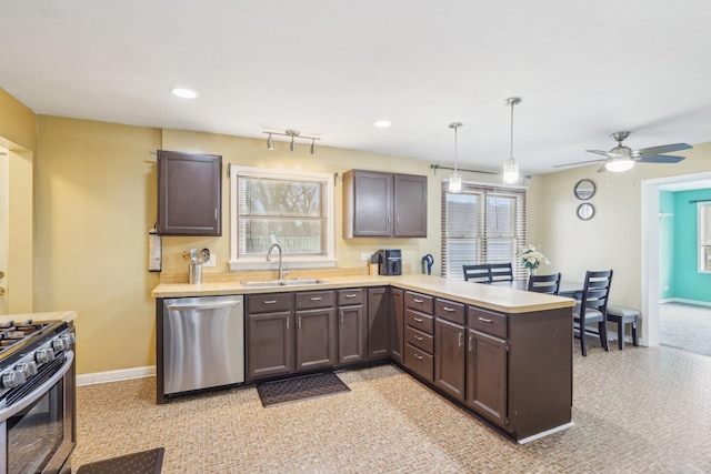 5800 Prospect Ave, Berkeley, IL 60163 - kitchen with stainless steel appliances, a peninsula, light countertops, dark brown cabinets, and hanging light fixtures