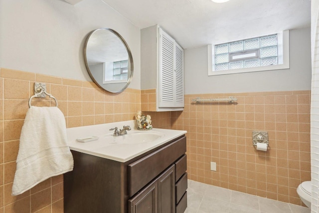 5800 Prospect Ave, Berkeley, IL 60163 - bathroom featuring tile walls, vanity, a wainscoted wall, and tile patterned flooring