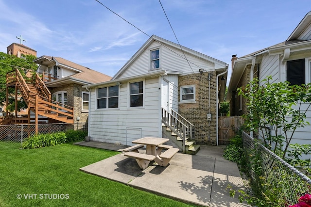 5404 W Henderson St, Chicago, IL 60641 - back of property with stairway, a patio area, and brick siding