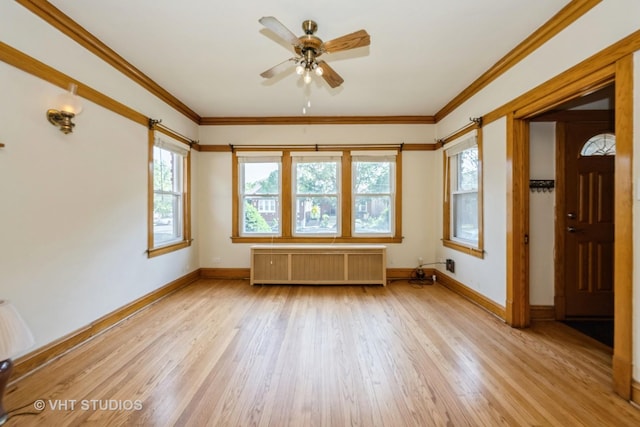 5404 W Henderson St, Chicago, IL 60641 - spare room featuring radiator heating unit, a ceiling fan, light wood finished floors, and ornamental molding