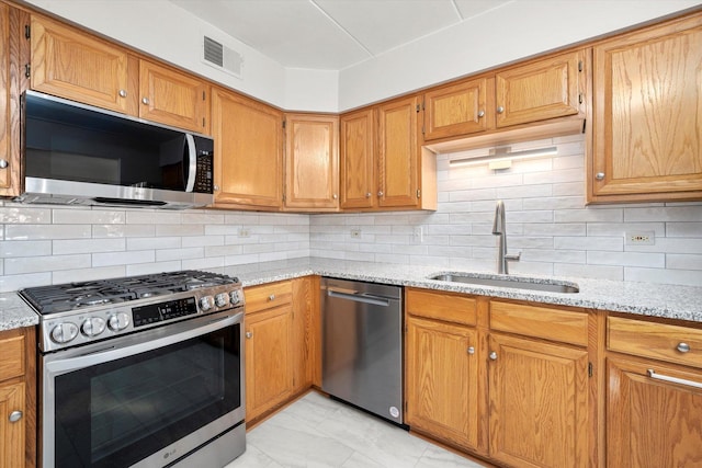 7515 Sheridan Dr Unit 1D, Willowbrook, IL 60527 - kitchen featuring appliances with stainless steel finishes, light stone counters, and backsplash