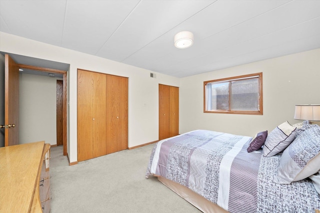 7515 Sheridan Dr Unit 1D, Willowbrook, IL 60527 - bedroom featuring light carpet and two closets