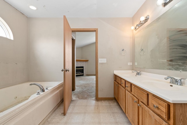 25813 S Geranium Ln, Monee, IL 60449 - bathroom featuring double vanity, a tub with jets, a glass covered fireplace, and tile patterned floors