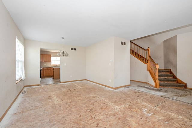 25813 S Geranium Ln, Monee, IL 60449 - unfurnished living room with a chandelier and stairway