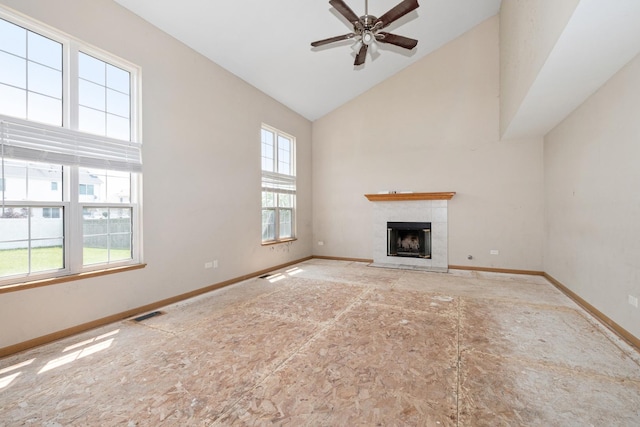 25813 S Geranium Ln, Monee, IL 60449 - unfurnished living room with high vaulted ceiling, a tiled fireplace, and a ceiling fan