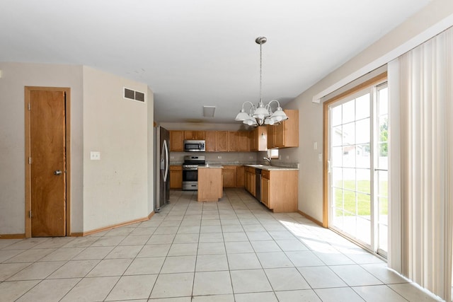 25813 S Geranium Ln, Monee, IL 60449 - kitchen featuring appliances with stainless steel finishes, a chandelier, light countertops, hanging light fixtures, and light tile patterned floors