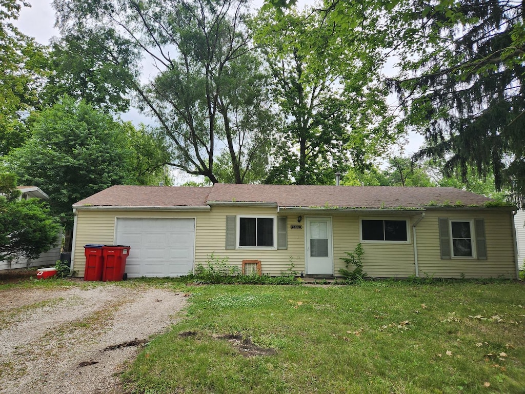 1306 Westfield Dr, Champaign, IL 61821 - ranch-style house featuring an attached garage, driveway, and a front yard