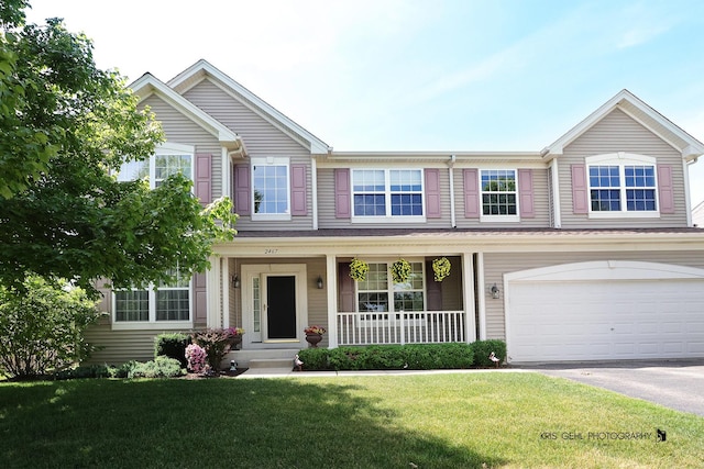 2467 W Autumn Dr, Round Lake, IL 60073 - traditional-style house with covered porch, an attached garage, a front lawn, and asphalt driveway