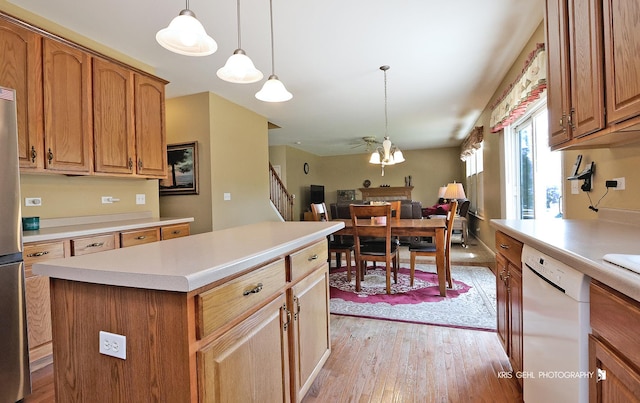 2467 W Autumn Dr, Round Lake, IL 60073 - kitchen with white dishwasher, light wood finished floors, a kitchen island, and light countertops