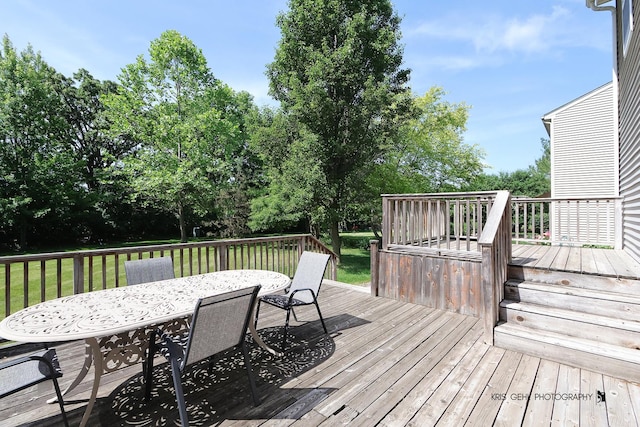 2467 W Autumn Dr, Round Lake, IL 60073 - wooden deck featuring outdoor dining area, a yard, and view of wooded area