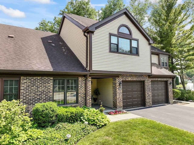 706 Brandon Pl, Wheeling, IL 60090 - view of front of home featuring brick siding, asphalt driveway, and an attached garage