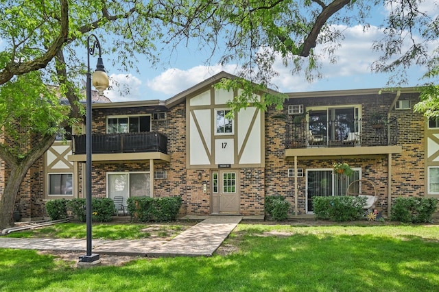 9S240 Lake Dr Unit 17-207B, Willowbrook, IL 60527 - tudor house with a balcony, a front yard, brick siding, and stucco siding