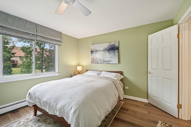 9S240 Lake Dr Unit 17-207B, Willowbrook, IL 60527 - bedroom featuring a baseboard heating unit, wood finished floors, and ceiling fan