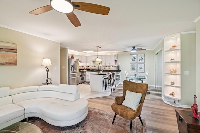 9S240 Lake Dr Unit 17-207B, Willowbrook, IL 60527 - living room with ceiling fan, light wood-style flooring, and crown molding