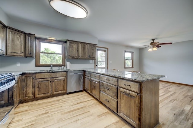 24460 Easy St, Plainfield, IL 60586 - kitchen with stainless steel appliances, a peninsula, light wood-style floors, ceiling fan, and light stone countertops