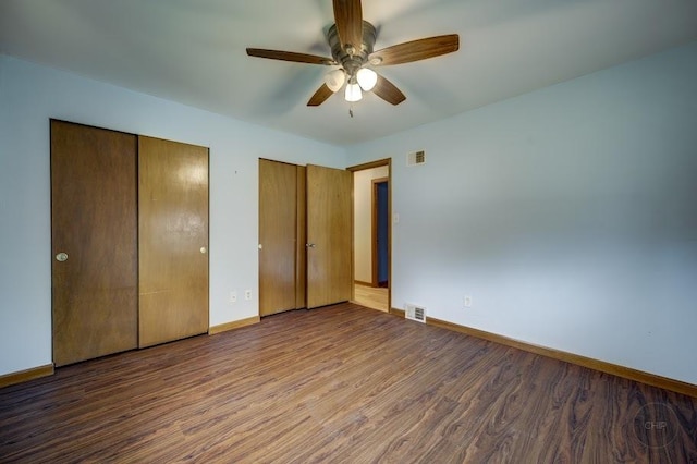 24460 Easy St, Plainfield, IL 60586 - unfurnished bedroom with two closets, wood finished floors, and a ceiling fan