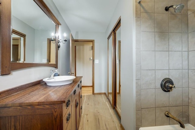 24460 Easy St, Plainfield, IL 60586 - full bathroom with vanity, wood finished floors, and shower / washtub combination