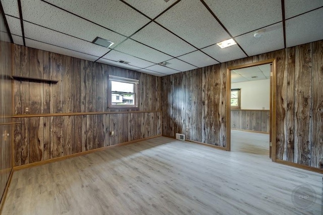 24460 Easy St, Plainfield, IL 60586 - spare room featuring a paneled ceiling, wooden walls, and wood finished floors