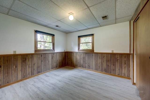 24460 Easy St, Plainfield, IL 60586 - unfurnished room featuring a drop ceiling, wainscoting, wood finished floors, and wood walls