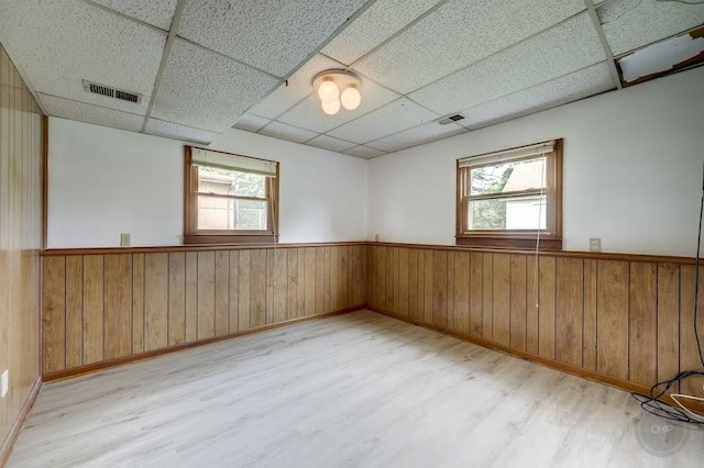 24460 Easy St, Plainfield, IL 60586 - spare room featuring wood finished floors, a paneled ceiling, wainscoting, and wood walls