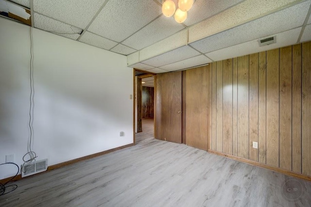 24460 Easy St, Plainfield, IL 60586 - empty room with a paneled ceiling, wood finished floors, and wood walls