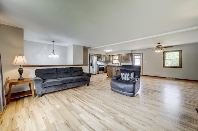 24460 Easy St, Plainfield, IL 60586 - living area featuring light wood finished floors, a chandelier, and ceiling fan