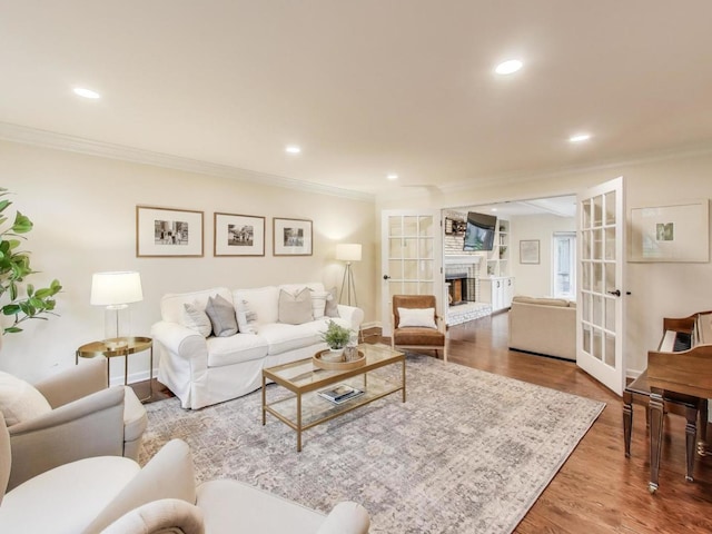 1664 Imperial Cir, Naperville, IL 60563 - living room with ornamental molding, wood finished floors, a fireplace with raised hearth, french doors, and recessed lighting
