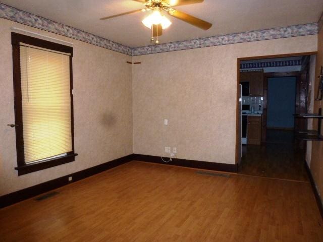 503 N Linden St, Clinton, IL 61727 - unfurnished room with dark wood-style floors and ceiling fan