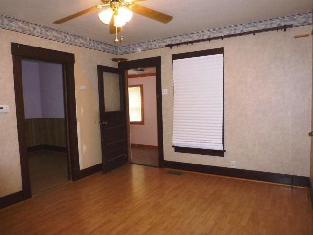 503 N Linden St, Clinton, IL 61727 - spare room with wood finished floors and a ceiling fan