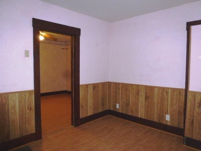 503 N Linden St, Clinton, IL 61727 - empty room with wainscoting, wood finished floors, and wooden walls