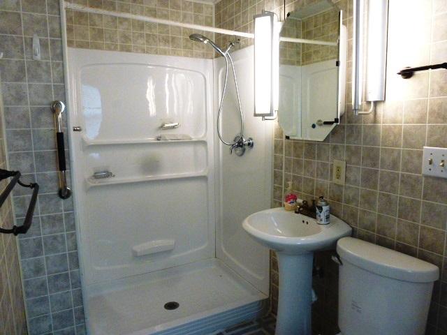 503 N Linden St, Clinton, IL 61727 - bathroom with a stall shower and tile walls