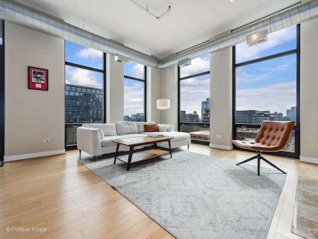 740 W Fulton St Unit 1202, Chicago, IL 60661 - living area featuring a view of city, a wall of windows, plenty of natural light, and wood finished floors