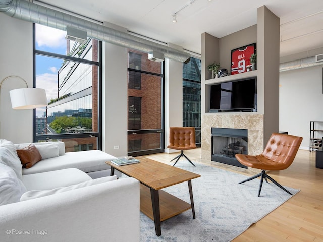 740 W Fulton St Unit 1202, Chicago, IL 60661 - living area featuring wood finished floors, expansive windows, a tile fireplace, and track lighting