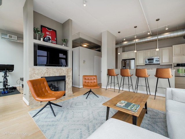 740 W Fulton St Unit 1202, Chicago, IL 60661 - living room with track lighting, light wood-style floors, and a fireplace