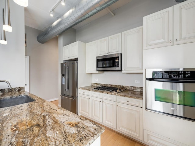 740 W Fulton St Unit 1202, Chicago, IL 60661 - kitchen featuring stainless steel appliances, stone countertops, light wood-style flooring, and white cabinetry