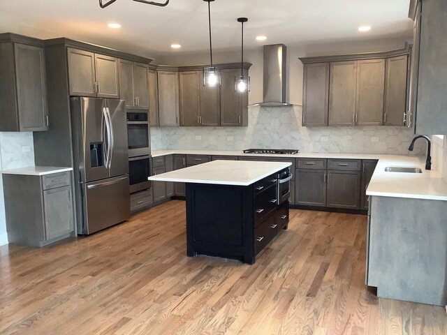 12415 Foxborough Dr, Mokena, IL 60448 - kitchen with appliances with stainless steel finishes, wall chimney range hood, a center island, light countertops, and backsplash