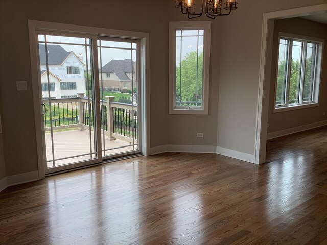 12415 Foxborough Dr, Mokena, IL 60448 - empty room featuring a chandelier and wood finished floors