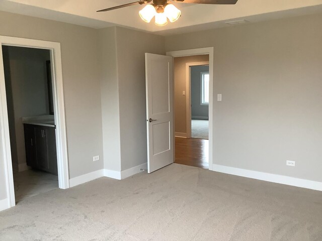 12415 Foxborough Dr, Mokena, IL 60448 - unfurnished bedroom featuring light carpet, ensuite bathroom, and a ceiling fan
