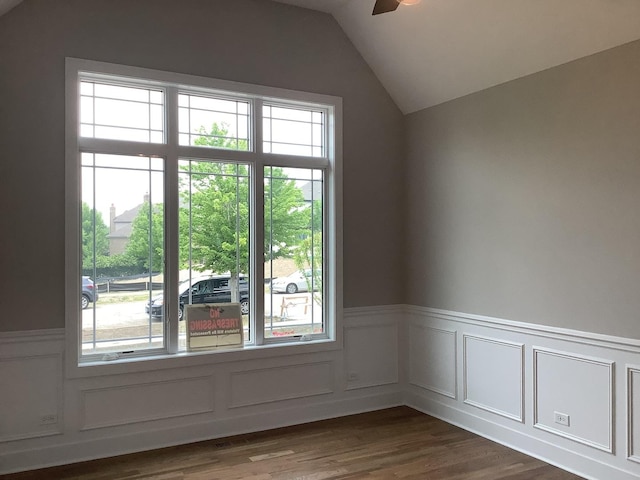 12415 Foxborough Dr, Mokena, IL 60448 - empty room featuring plenty of natural light, a ceiling fan, a wainscoted wall, vaulted ceiling, and dark wood finished floors