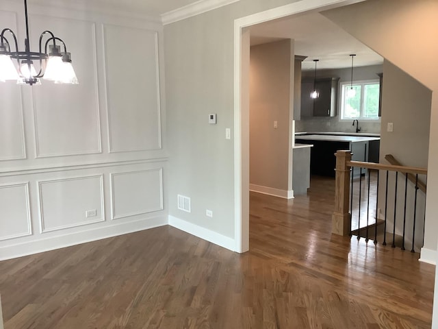 12415 Foxborough Dr, Mokena, IL 60448 - unfurnished dining area with a chandelier, dark wood finished floors, and ornamental molding