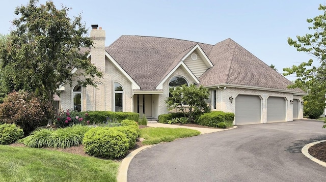 10652 Lexington Ct, Frankfort, IL 60423 - view of front facade with brick siding, a garage, a chimney, and roof with shingles