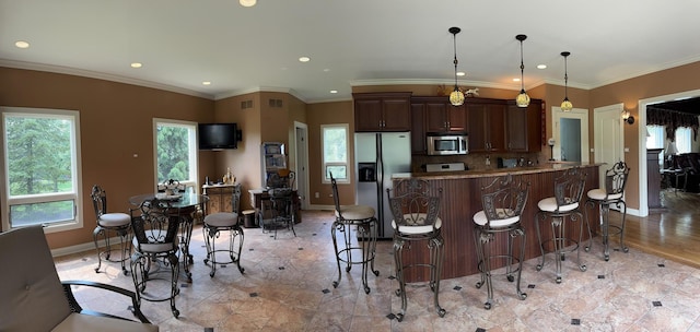 10652 Lexington Ct, Frankfort, IL 60423 - kitchen featuring appliances with stainless steel finishes, a kitchen breakfast bar, recessed lighting, decorative light fixtures, and dark brown cabinetry