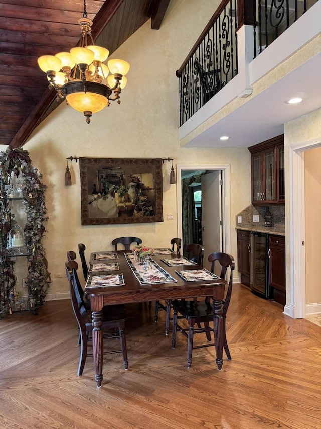 10652 Lexington Ct, Frankfort, IL 60423 - dining space with wine cooler, light wood-type flooring, a chandelier, a wood ceiling with exposed beams, and high vaulted ceiling