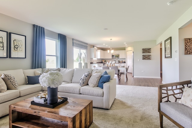 1759 Breton Ave, North Aurora, IL 60542 - living area featuring a chandelier, light carpet, and light wood-style floors