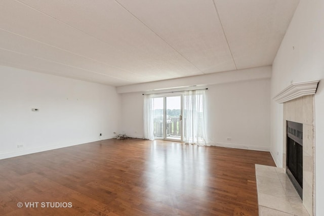 12900 W Heiden Cir Unit 4304, Lake Bluff, IL 60044 - unfurnished living room with a tiled fireplace and light wood-style floors