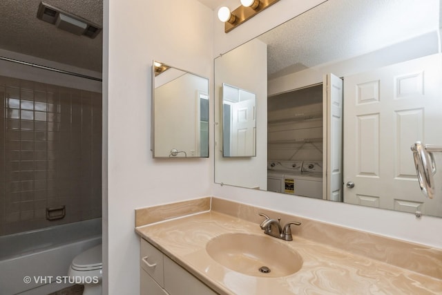 12900 W Heiden Cir Unit 4304, Lake Bluff, IL 60044 - bathroom with washing machine and dryer, vanity, and a textured ceiling